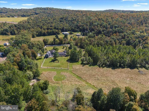 an aerial view of a houses with a yard