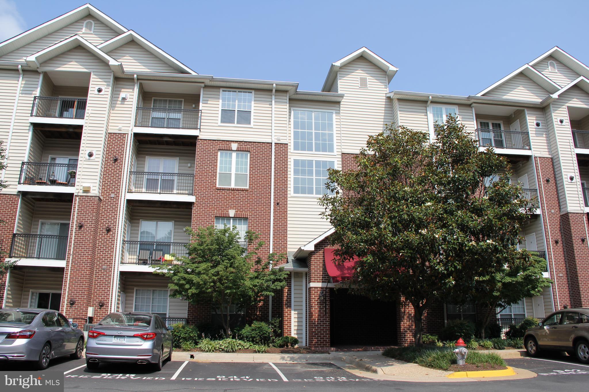 1580 Spring Gate Dr., Unit 4102 McLean, VA 22102 - Photo 1 of 26 a city street lined with buildings and cars