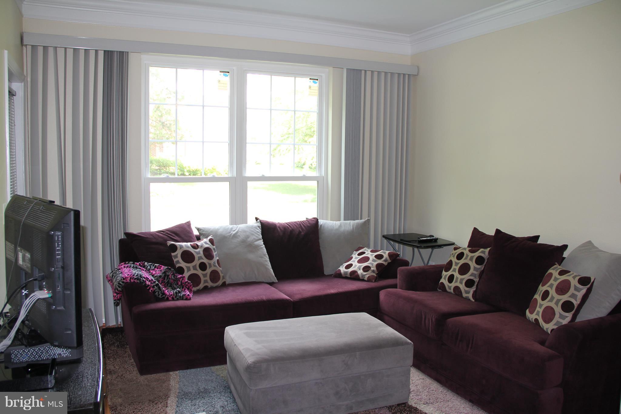 1580 Spring Gate Dr., Unit 4102 McLean, VA 22102 - Photo 4 of 26 a living room with furniture and a window