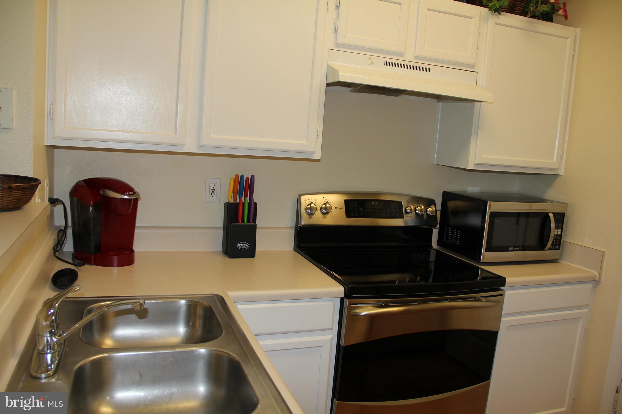 1580 Spring Gate Dr., Unit 4102 McLean, VA 22102 - Photo 7 of 26 a kitchen with a sink and cabinets