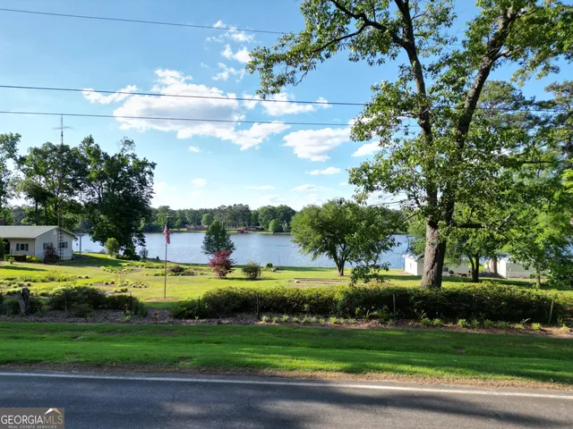 a view of a chairs and table in patio with swimming pool