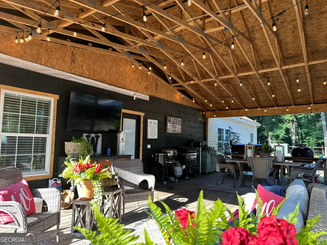 a kitchen with stainless steel appliances kitchen island granite countertop a table chairs and a stove