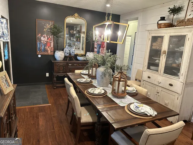 a large kitchen with stainless steel appliances a large counter top a stove and a sink with dishwasher