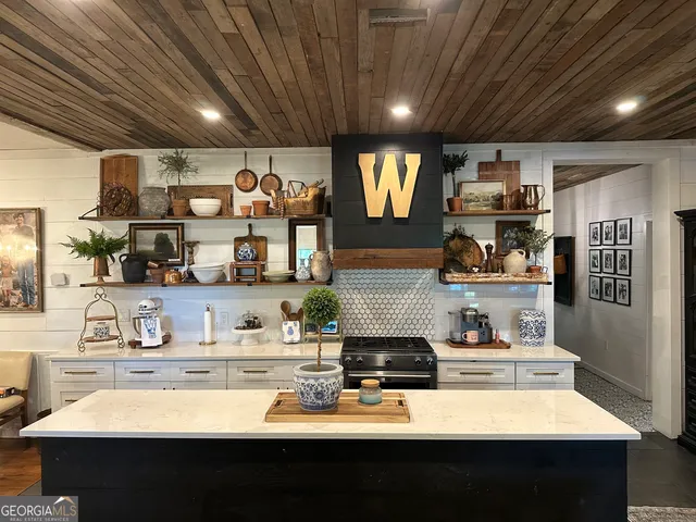 a living room with couches a fireplace and a flat screen tv