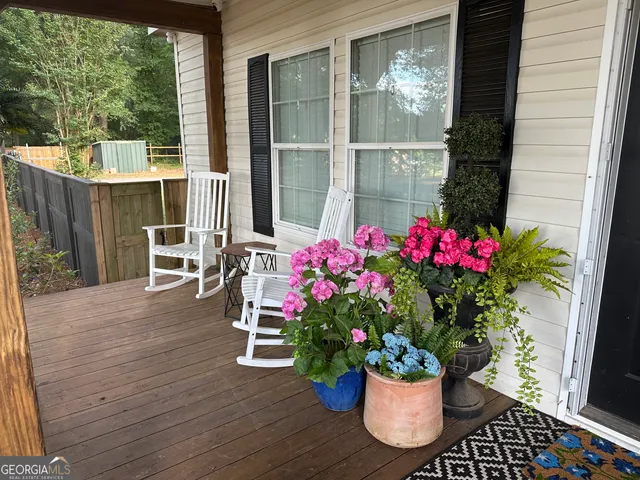 a wooden bench sitting in front of a house