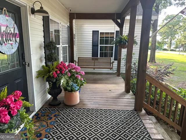 a view of backyard with wooden fence and a large tree