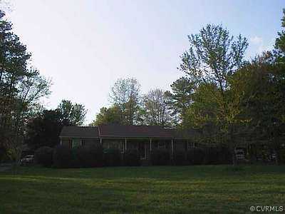 a front view of house with a garden
