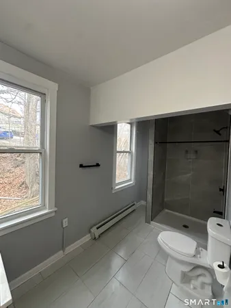a bathroom with a toilet a sink and shower