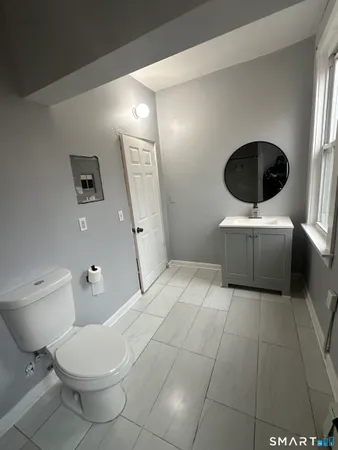 a bathroom with a toilet and a vanity