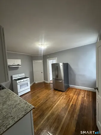 a kitchen with granite countertop a stove and a sink
