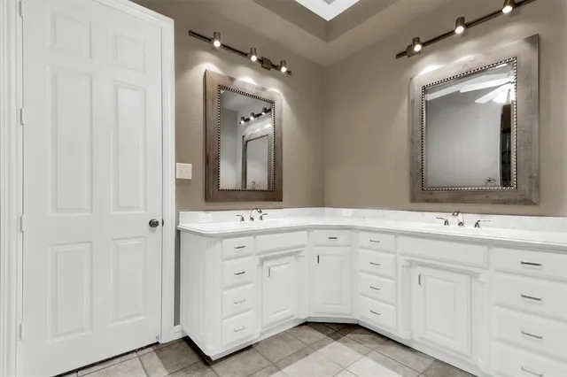 a bathroom with a double vanity sink and mirror