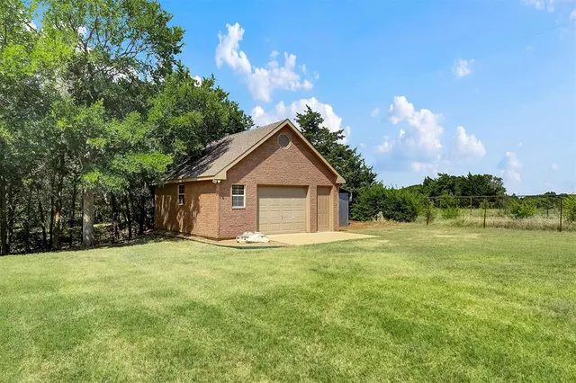 a view of a house with yard and a tree