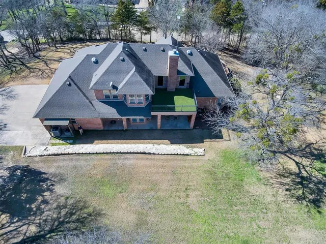 an aerial view of a house with a yard