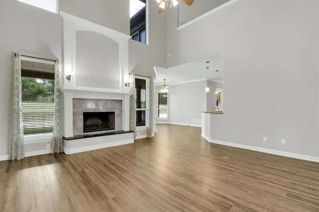 a view of a livingroom with wooden floor and a fireplace