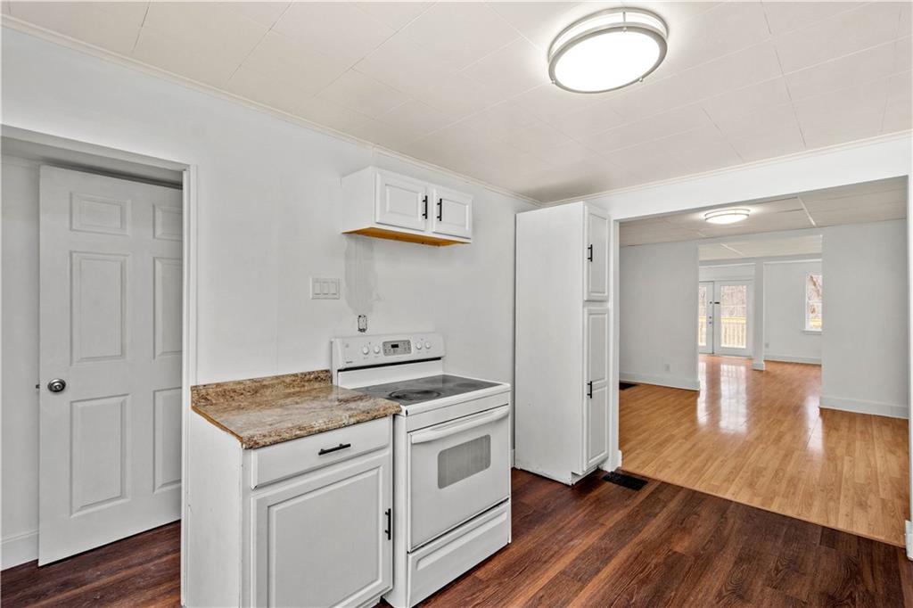 15 Maple Street Scenery Hill, PA 15360 - Photo 6 of 24 an empty room with wooden floor and cabinet