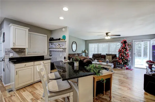 a kitchen with sink refrigerator and microwave