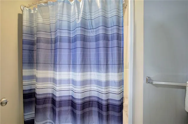 a bathroom with a sink and a shower curtain