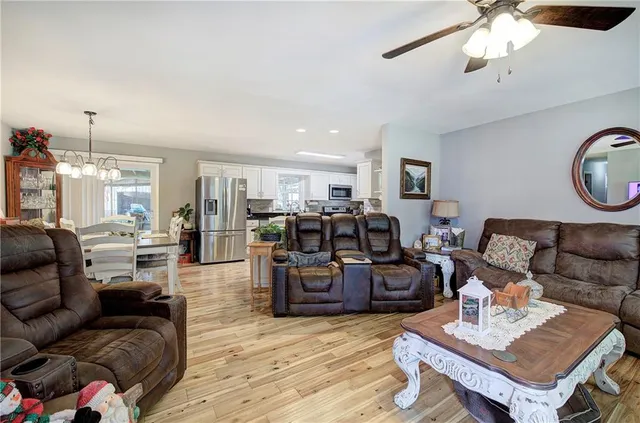 a living room with furniture and kitchen view