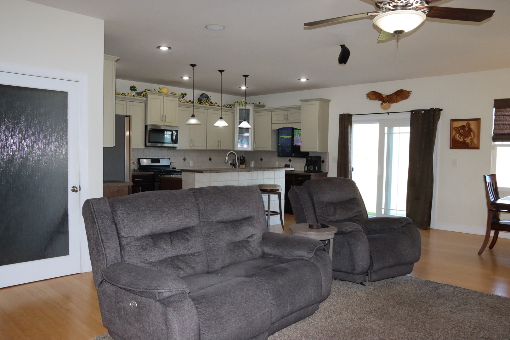 306 South 3rd Street Ashkum, IL 60911 - Photo 12 of 50 a living room with couches and kitchen view with wooden floor
