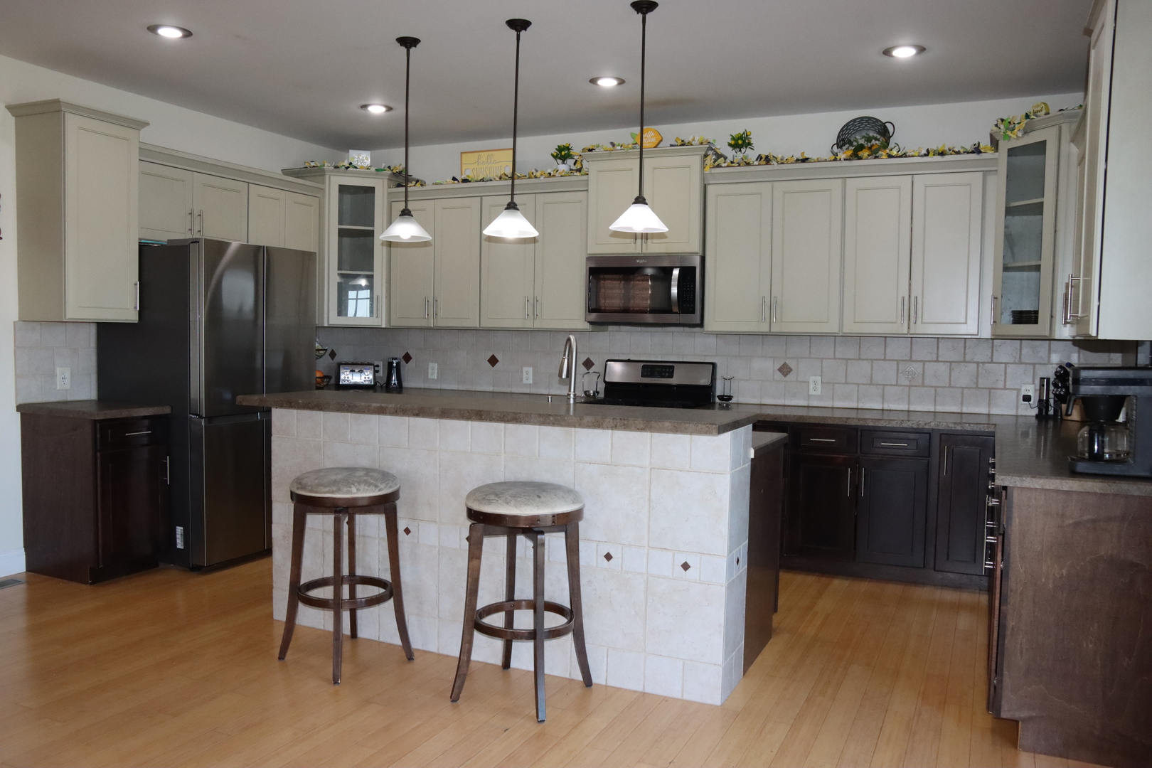 306 South 3rd Street Ashkum, IL 60911 - Photo 14 of 50 a kitchen with kitchen island granite countertop a sink a center island a refrigerator and a stove