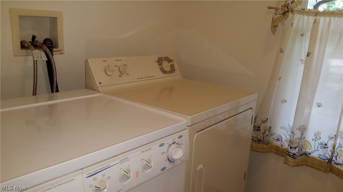 2123 Conwill Road Stow, OH 44224 - Photo 16 of 24 Freshly painted laundry room with large window, and washer and dryer stays.