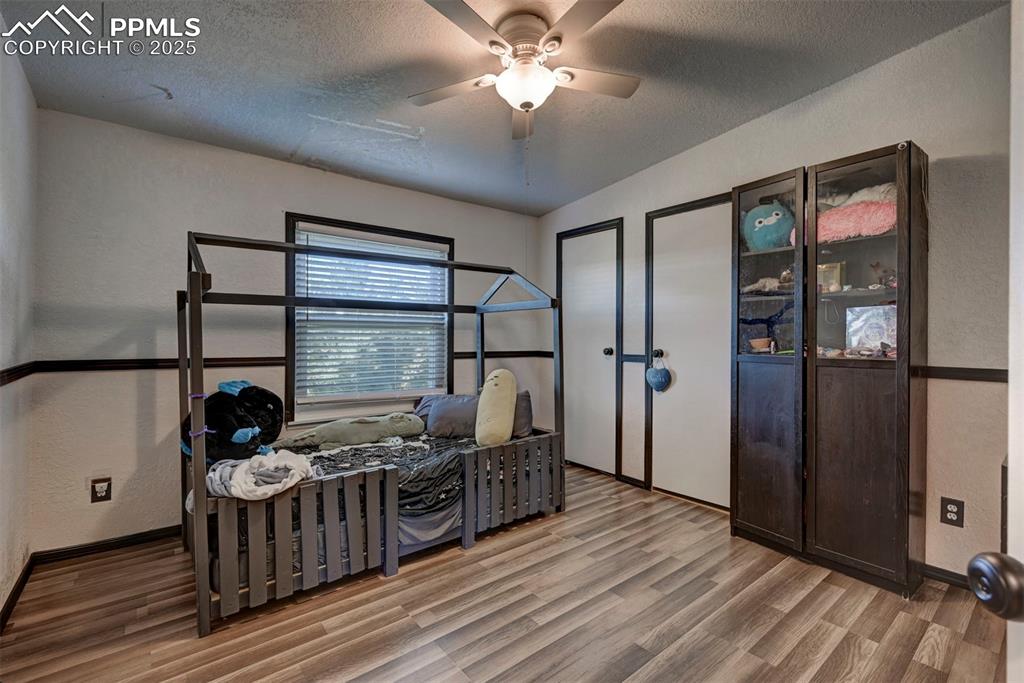 35355 Funk Road Calhan, CO 80808 - Photo 26 of 31 a bedroom with furniture window and wooden floor