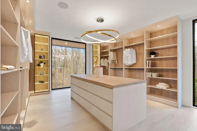 a kitchen with stainless steel appliances granite countertop a sink a stove and a microwave