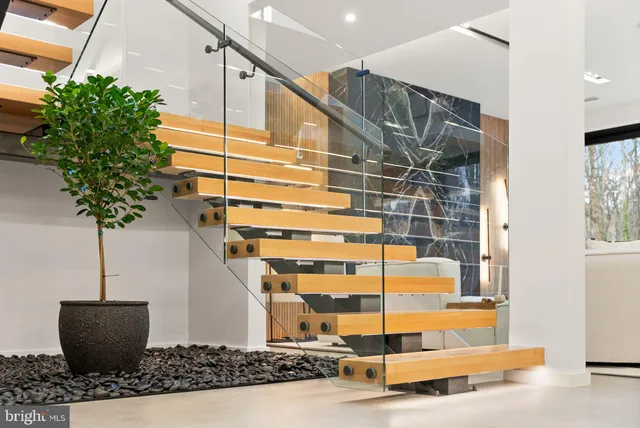 a front view of a house with yard and parking