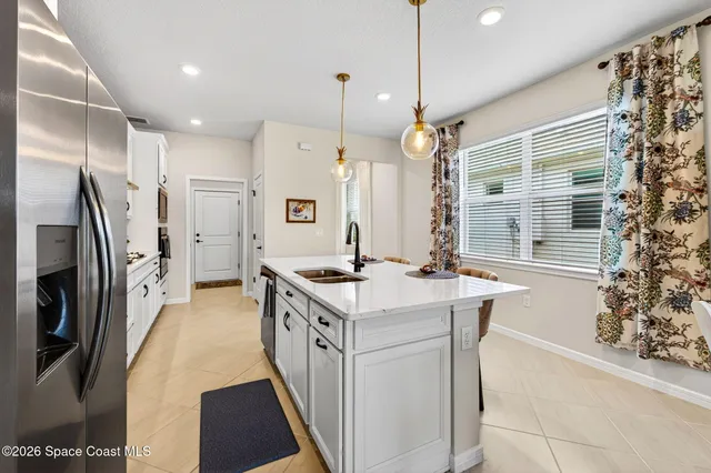 a view of a dining room with furniture and a chandelier
