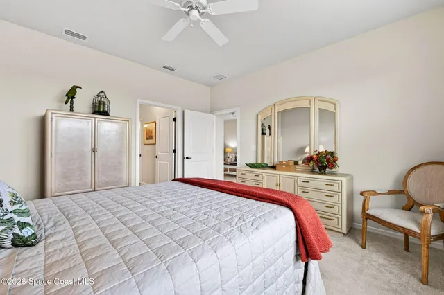 a bedroom with a bed and cabinets