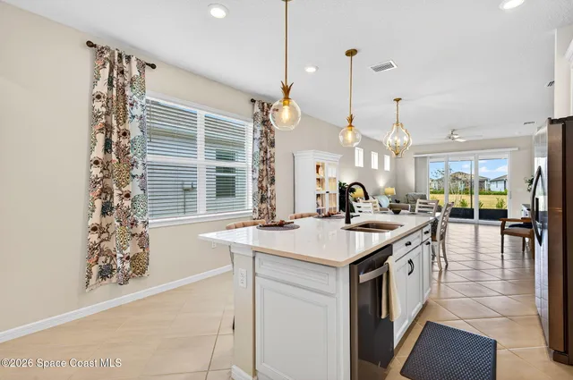 a kitchen with stainless steel appliances a stove a refrigerator a sink and a refrigerator