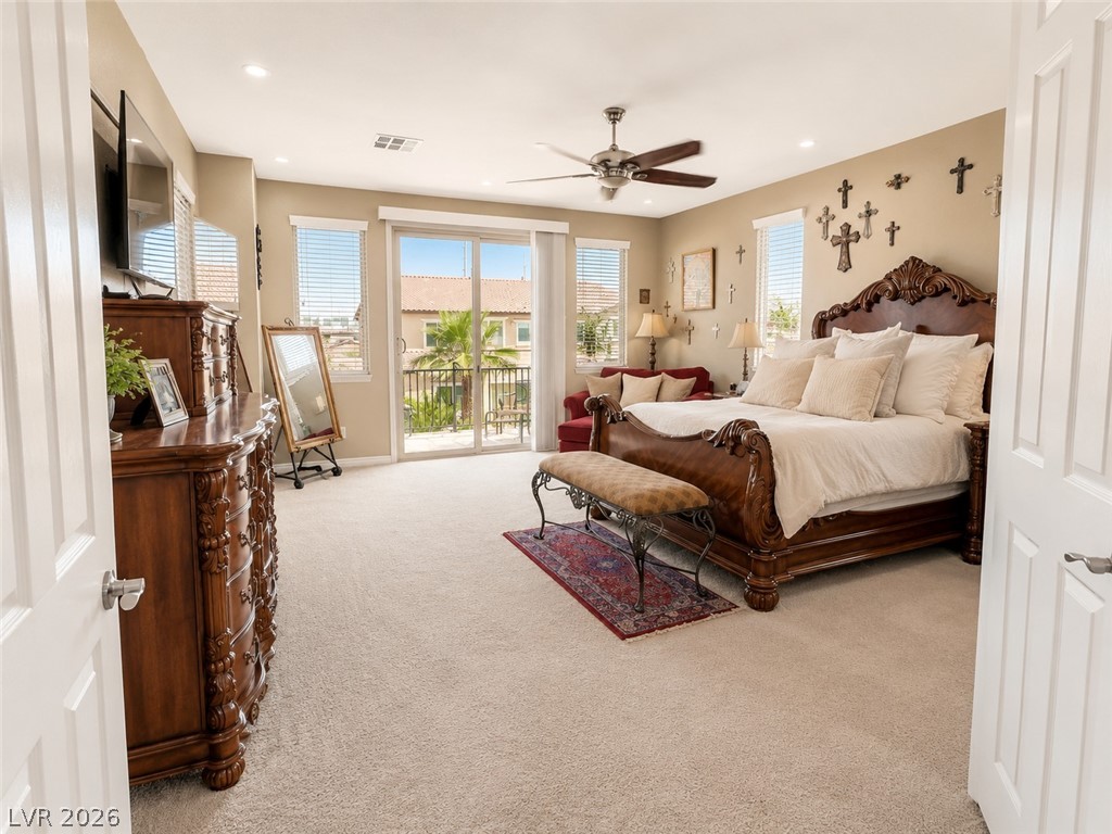 9724 University Ridge Avenue Las Vegas, NV 89149 - Photo 52 of 61 A comfortable bedroom with a spacious balcony access, offering elevated neighborhood views.