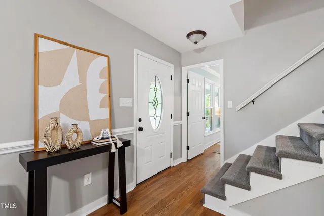 a living room with furniture a rug and a chandelier