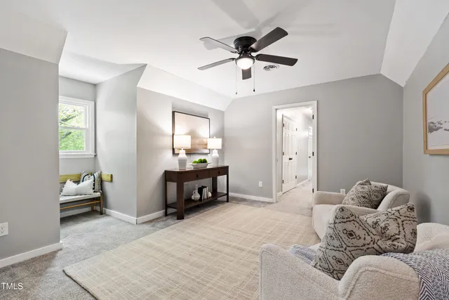 a living room with furniture and a ceiling fan
