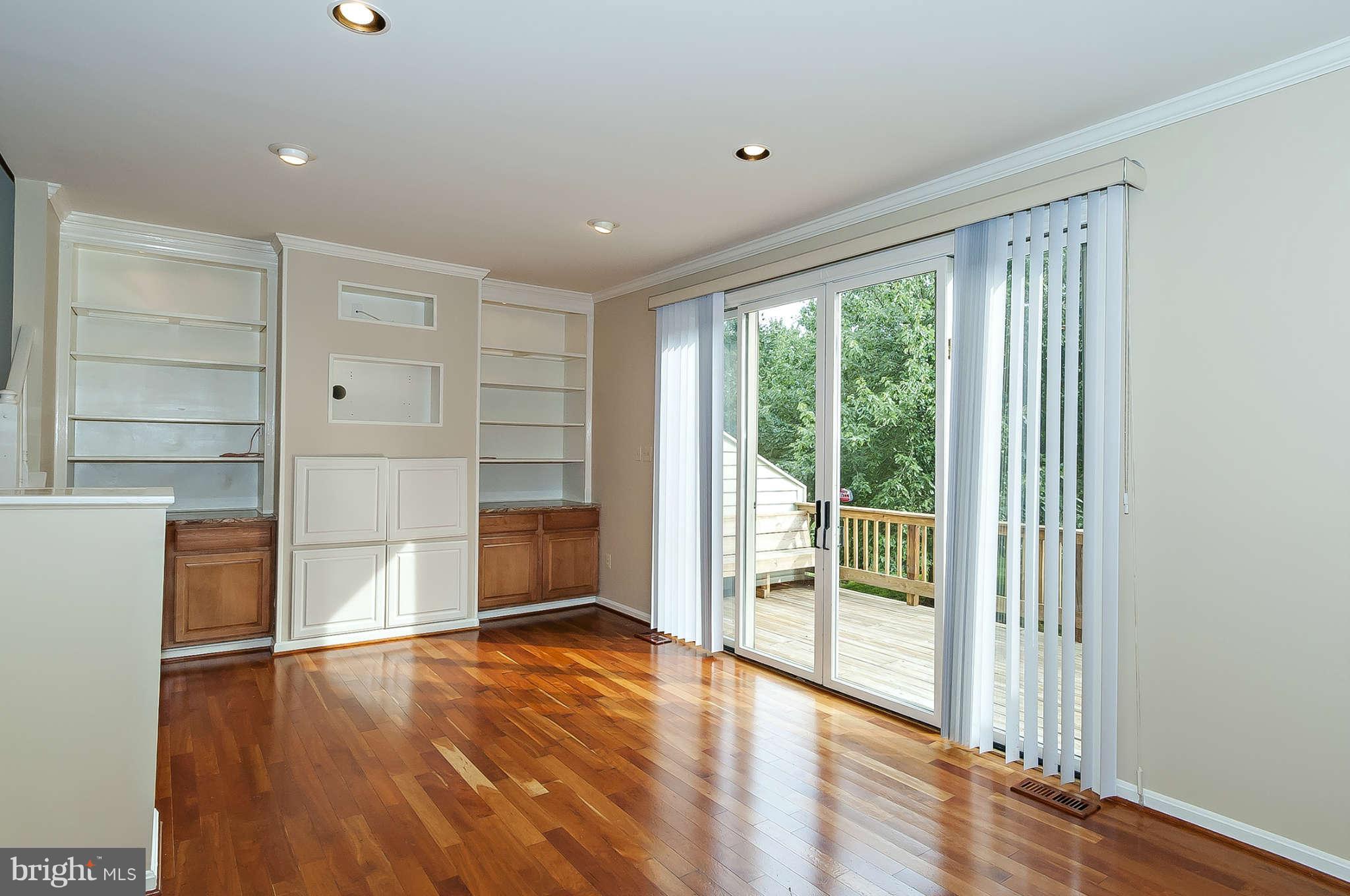 LIVING ROOM WITH BUILT INS  AND CHERRY FLOORS