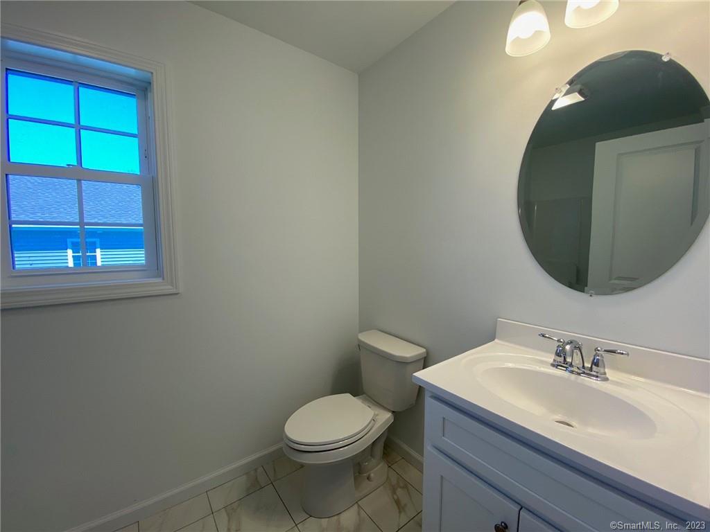 47 Rowland Farm Road, Unit 28 Oxford, CT 06478 - Photo 11 of 16 a bathroom with a toilet sink and mirror