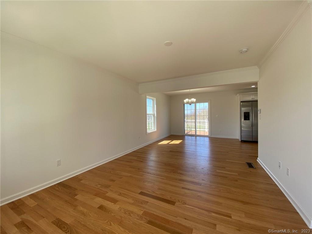 47 Rowland Farm Road, Unit 28 Oxford, CT 06478 - Photo 2 of 16 a view of empty room with wooden floor and fan