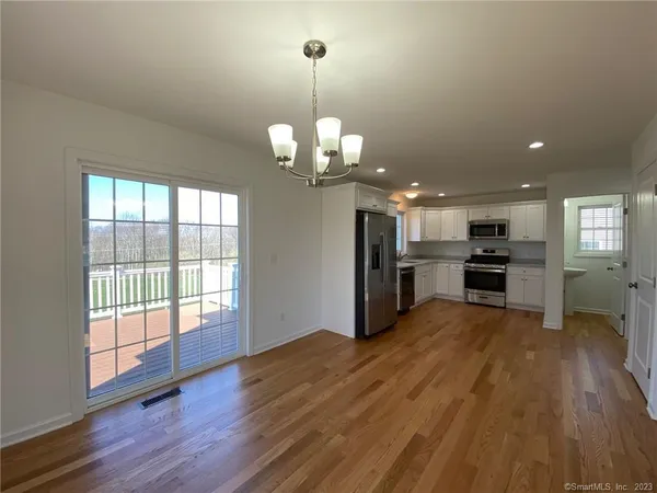 a view of a kitchen with stove and wooden floor