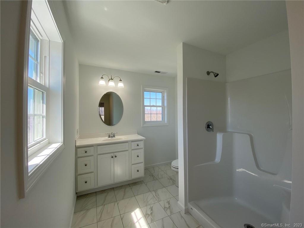 47 Rowland Farm Road, Unit 28 Oxford, CT 06478 - Photo 10 of 16 a bathroom with a sink mirror and shower