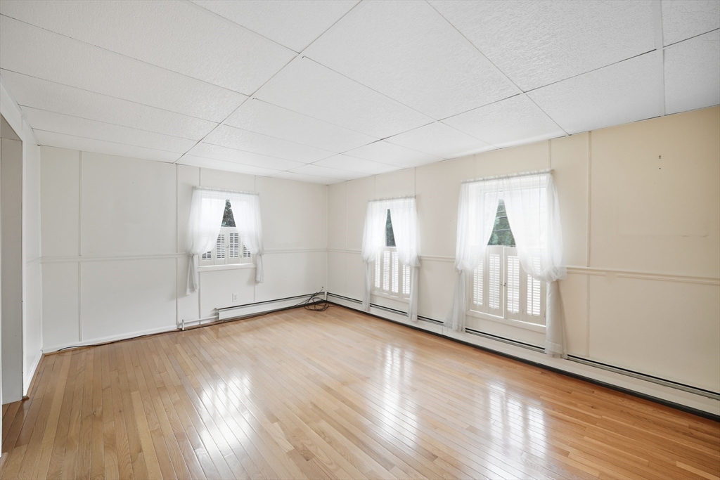 254 Route 20 Chester, MA 01011 - Photo 18 of 38 an empty room with wooden floor and windows