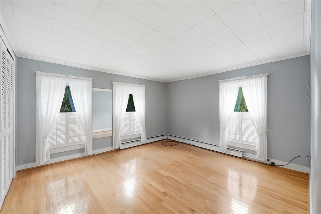 254 Route 20 Chester, MA 01011 - Photo 20 of 38 an empty room with wooden floor and windows