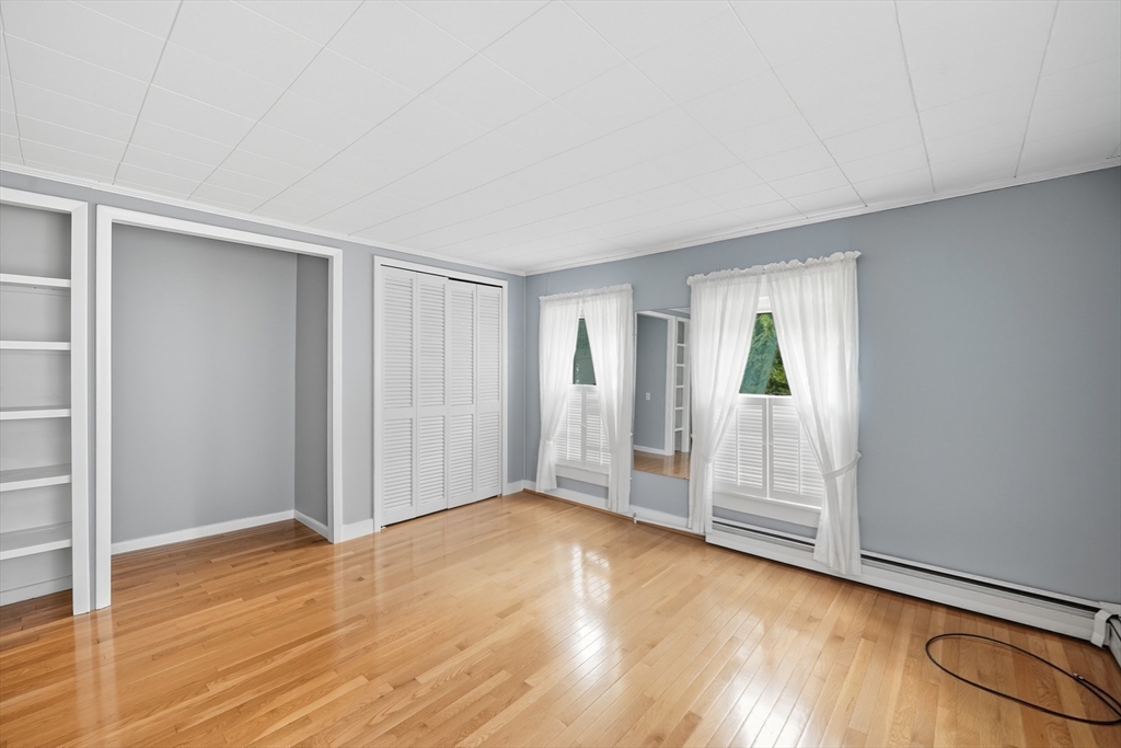 254 Route 20 Chester, MA 01011 - Photo 21 of 38 an empty room with wooden floor and windows