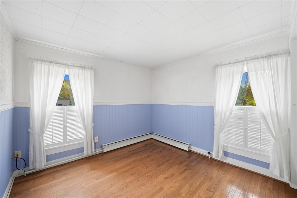 254 Route 20 Chester, MA 01011 - Photo 23 of 38 an empty room with wooden floor and windows