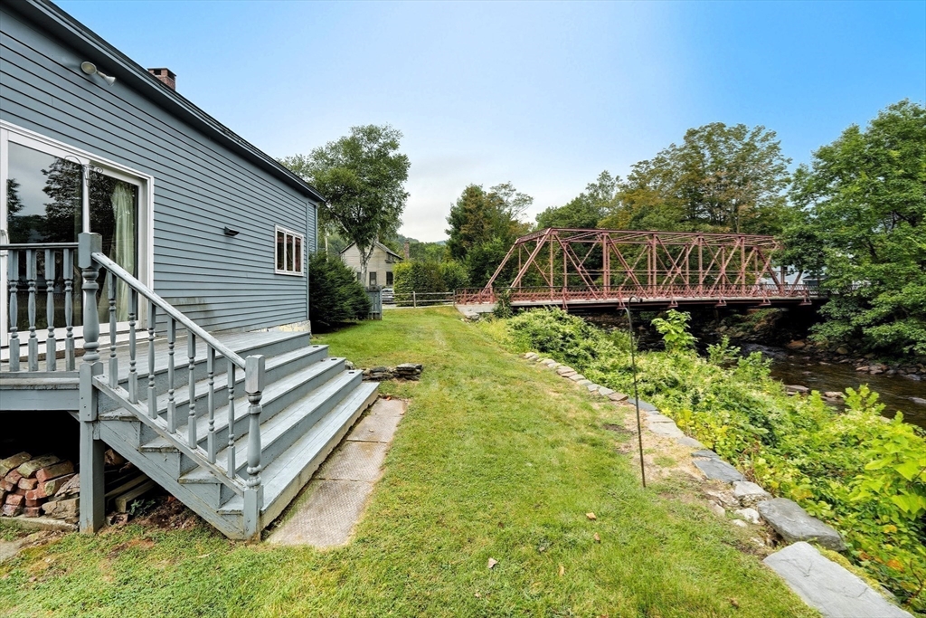 254 Route 20 Chester, MA 01011 - Photo 31 of 38 a view of a house with wooden deck and a yard