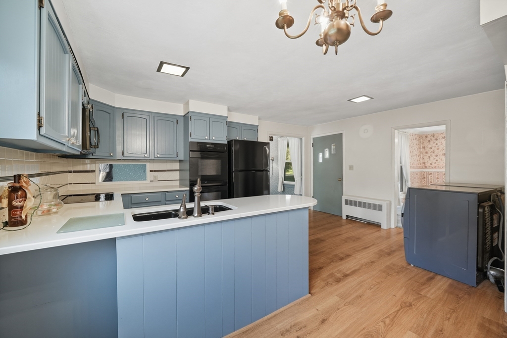 254 Route 20 Chester, MA 01011 - Photo 4 of 38 a kitchen with kitchen island stainless steel appliances a sink refrigerator stove and wooden floor