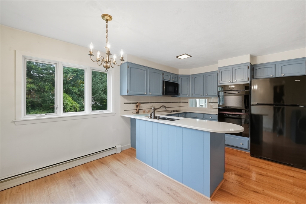 254 Route 20 Chester, MA 01011 - Photo 5 of 38 a kitchen with stainless steel appliances granite countertop a refrigerator a sink dishwasher a stove and white countertops with wooden floor