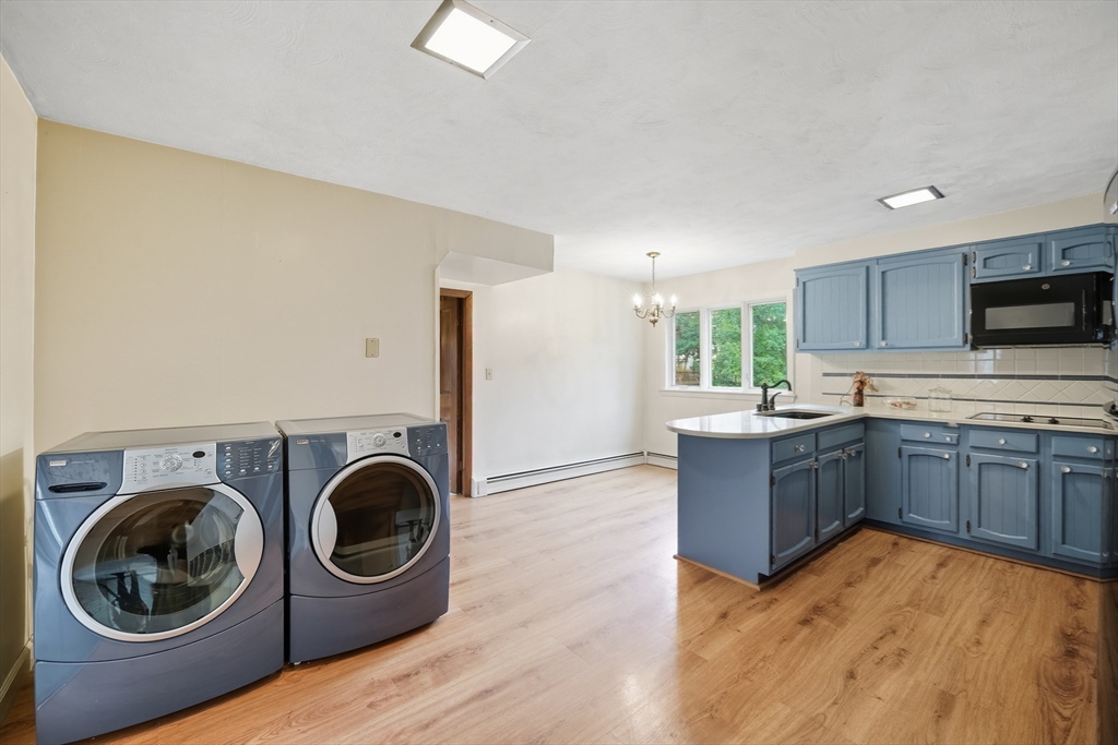 254 Route 20 Chester, MA 01011 - Photo 6 of 38 a kitchen with stainless steel appliances granite countertop a sink a stove top oven and wooden floors