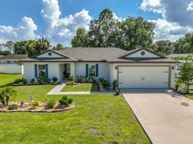 a front view of a house with a yard table and chairs