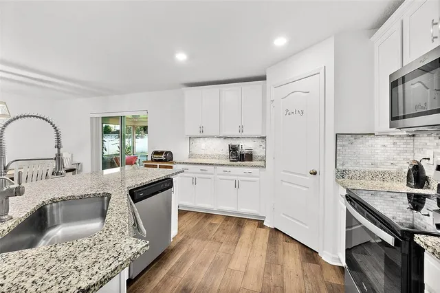 a kitchen with a sink stove and refrigerator