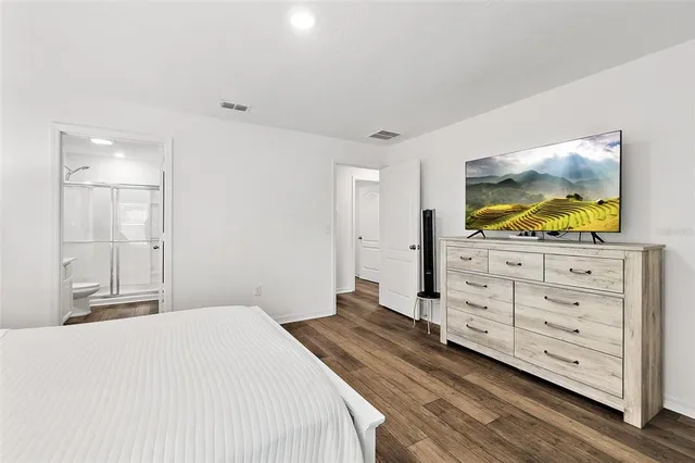 a bedroom with a bed and a dresser